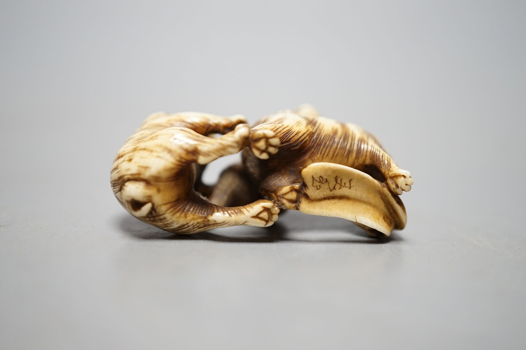 A Japanese ivory netsuke monkey group, 19th century, signed, 5cm wide.